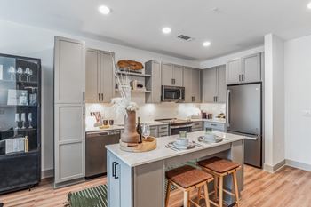 A kitchen with a large island and stainless steel appliances
